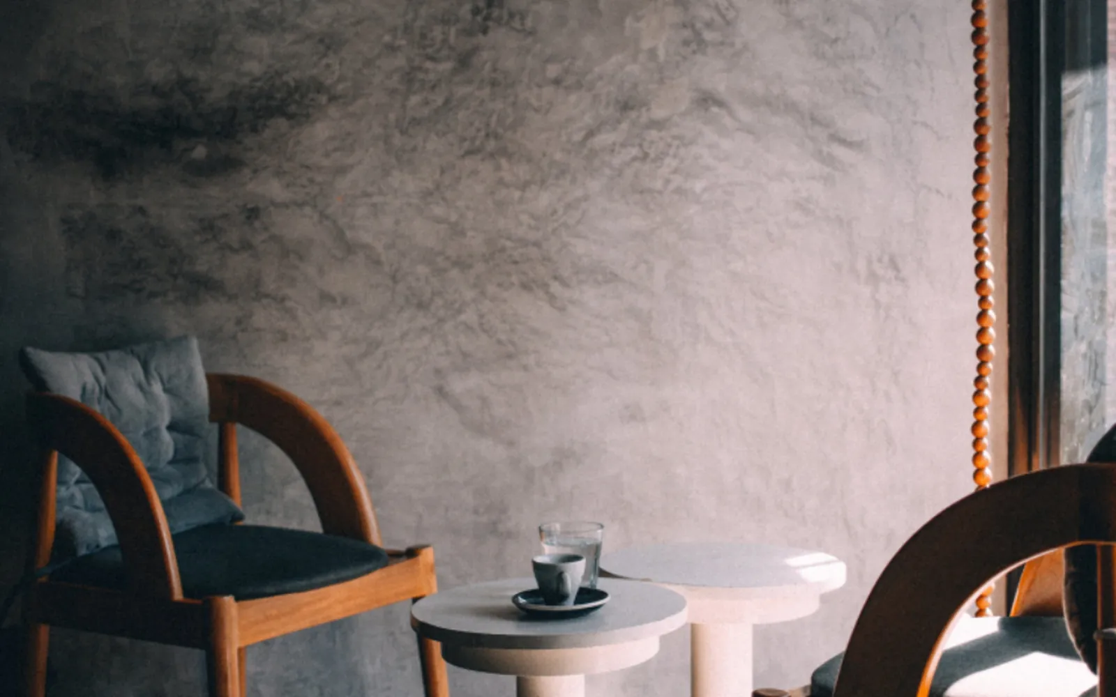 Daylight on a wall beside a chair and coffee table